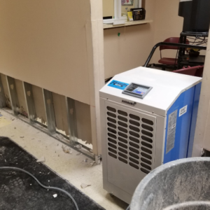 Flood Water Reclamation and Removal interior with commercial dehumidifier.